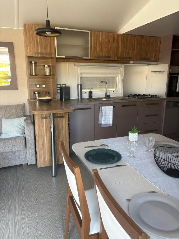 a kitchen with a table with chairs and a dining room at Nadege in Lège-Cap-Ferret