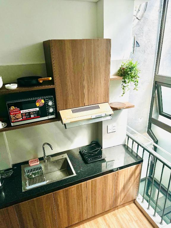 a kitchen with a sink and a counter top at Happy House in Danang