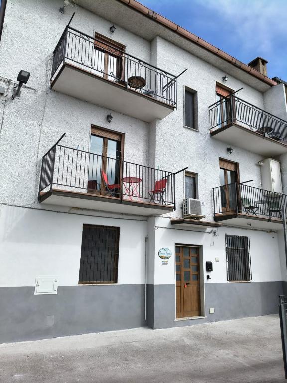 a building with balconies and tables and chairs on it at La Casa Dei Nonni in Agerola