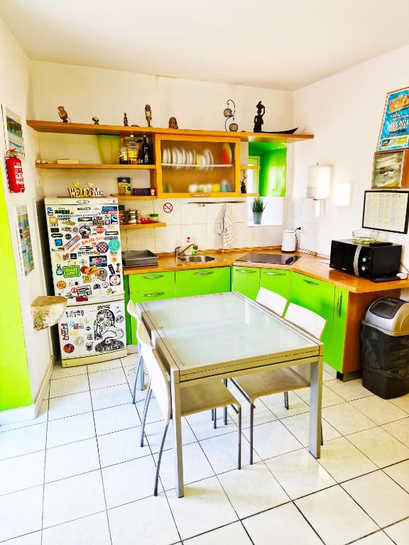 a kitchen with green cabinets and a table in it at Croparadise Central in Split
