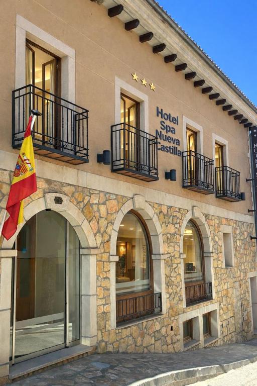 a building with a flag on the side of it at Vestigia Nueva Castilla in Sigüenza