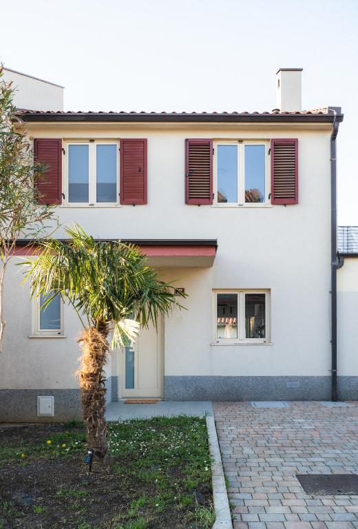 a house with a palm tree in front of it at Villa Leo in Koper