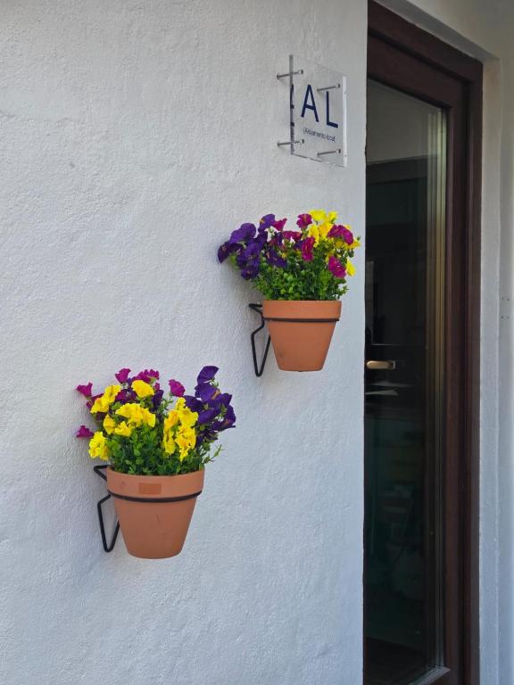 two flower pots on the side of a building at Pátio do Tear in Sobreira Formosa