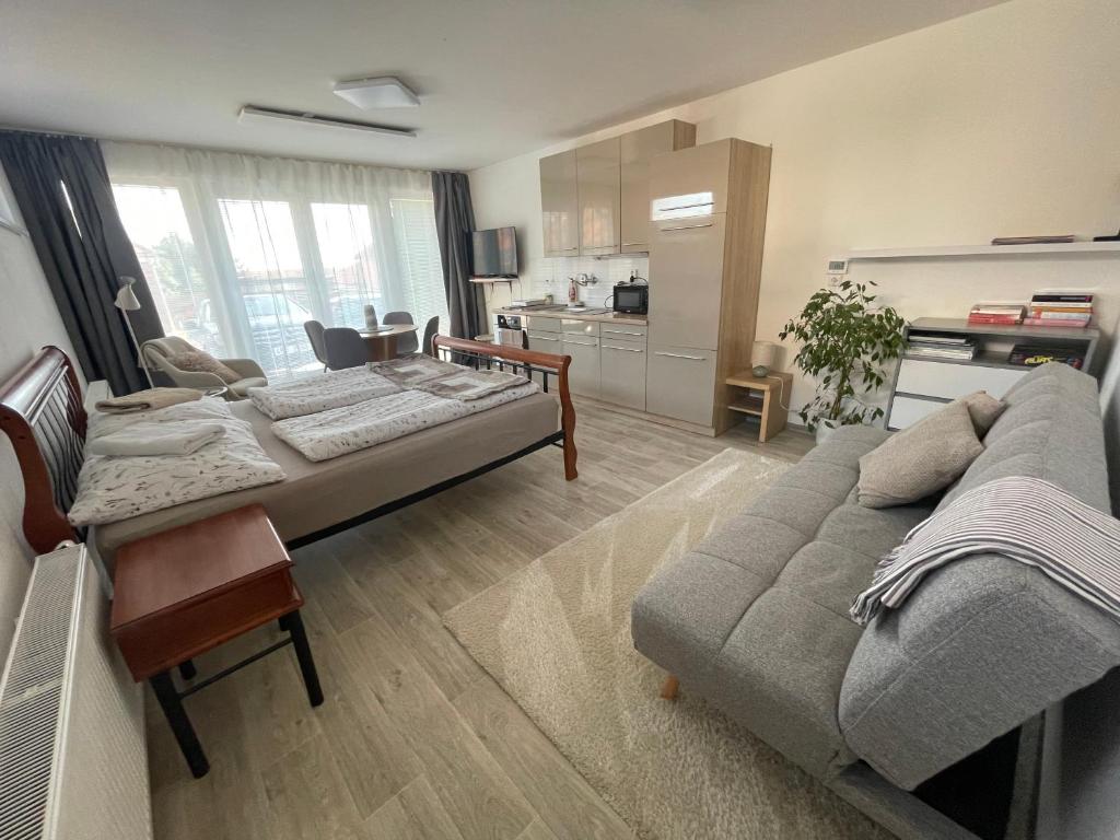 a living room with a bed and a couch at Apartmán Mašovice u Znojma in Mašovice