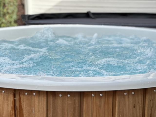 a hot tub filled with blue water on top at Chalet Ivoire in Durbuy