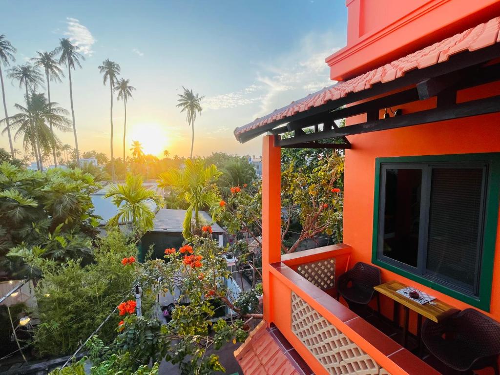 a balcony of a house with a view of a garden at Orange Villa Muine in Mui Ne