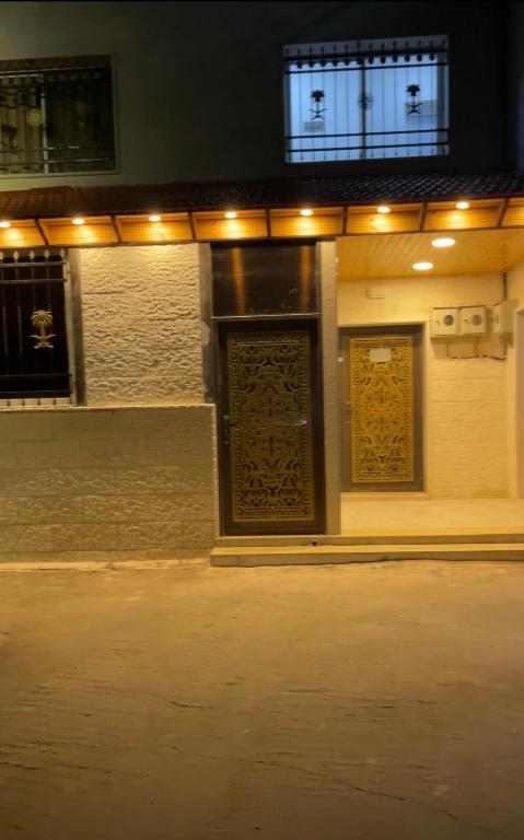 a building with two doors on a street at night at درة عبين الدور الارضي 2 in ‘Ibbīn