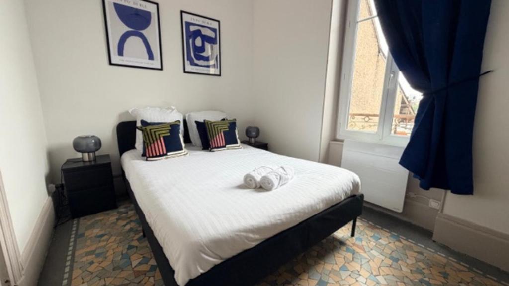 a bedroom with a bed with two towels on it at Escapade sur la Loire in Nevers