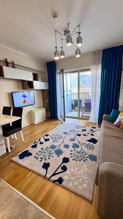 a living room with a couch and a table and a television at Sea view apartment 2 in Boreti