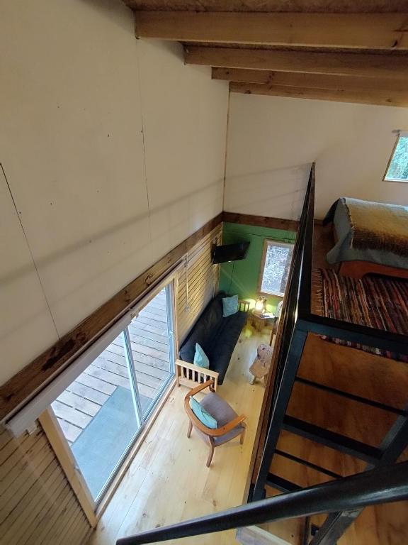 an overhead view of a room with a staircase in a house at Refugió Chaicura in Chonchi