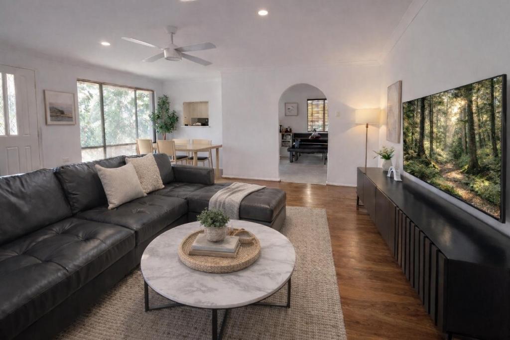a living room with a couch and a table at Humble & Homely in Rockingham
