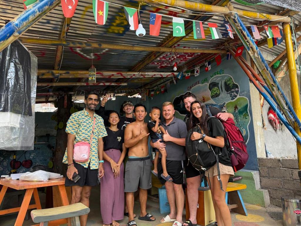 a group of people standing in front of a building at Family Hostel Lovina in Lovina