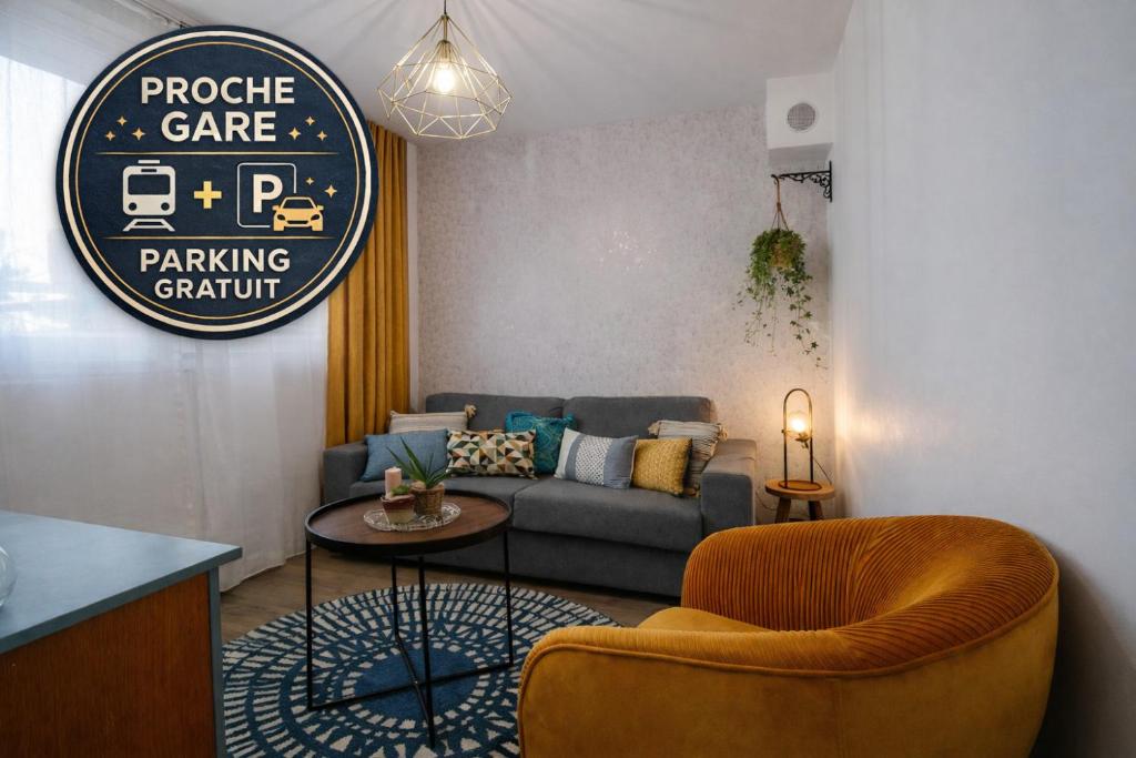 a living room with a couch and a table at Le Rétro de la Gare - FloBNB in Laon
