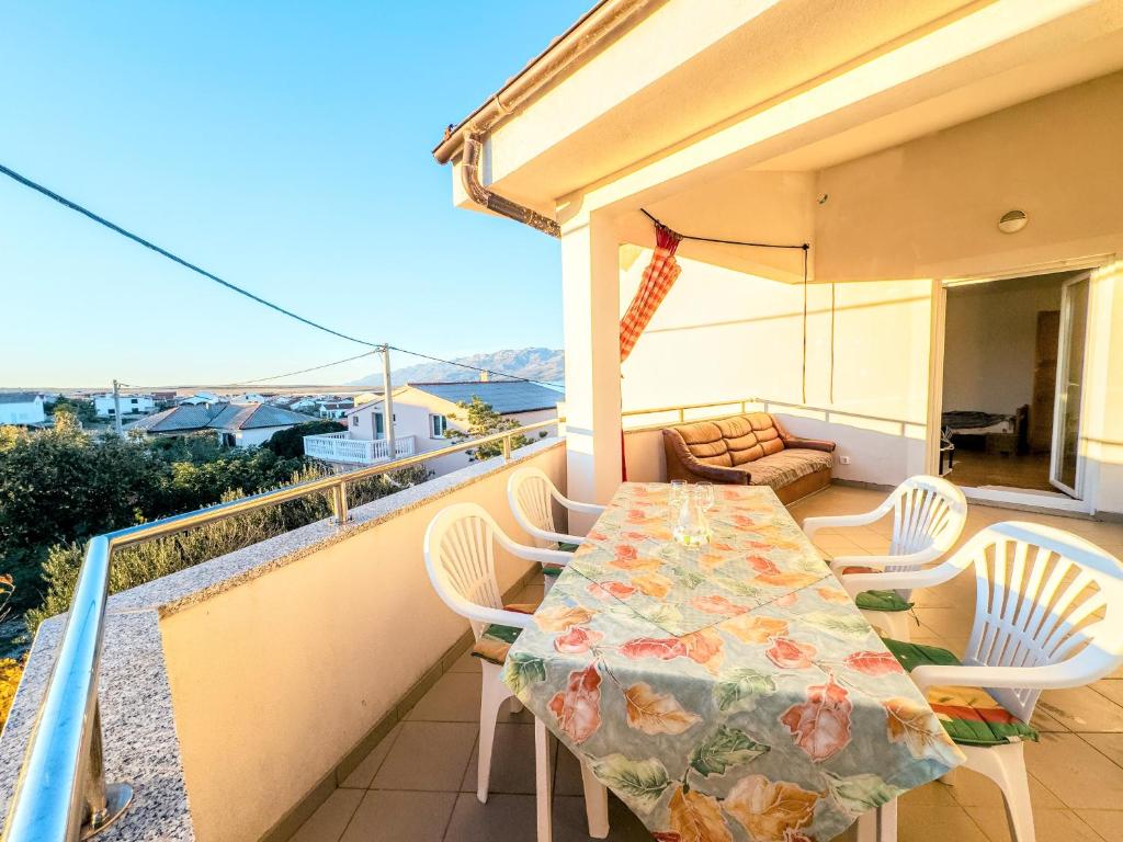 a table and chairs on the balcony of a house at Haus Ljubica Ražanac in Ražanac