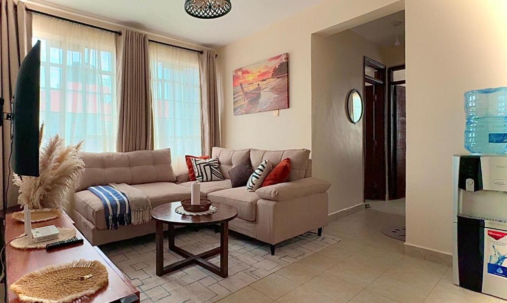 a living room with a couch and a table at My Humble Abode - Machakos in Machakos
