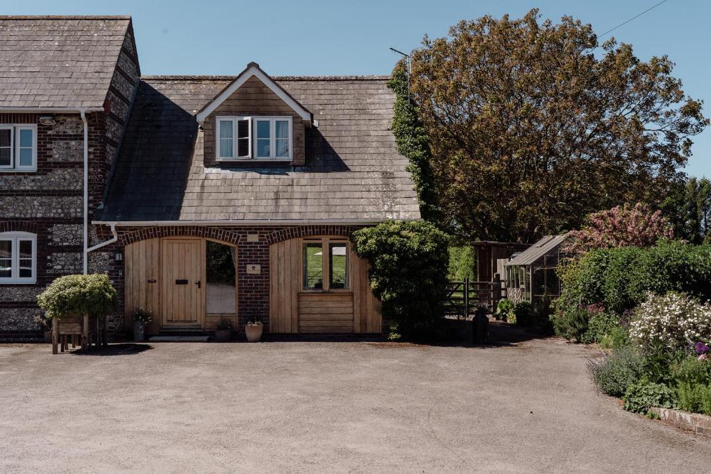 a house with a large driveway in front of it at Tokenhill Cottage in Dorchester
