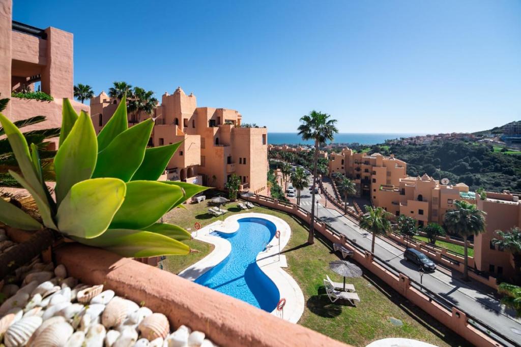 a view from the balcony of a resort with a swimming pool at Seaview Apartment - COTO REAL Duquesa in Manilva