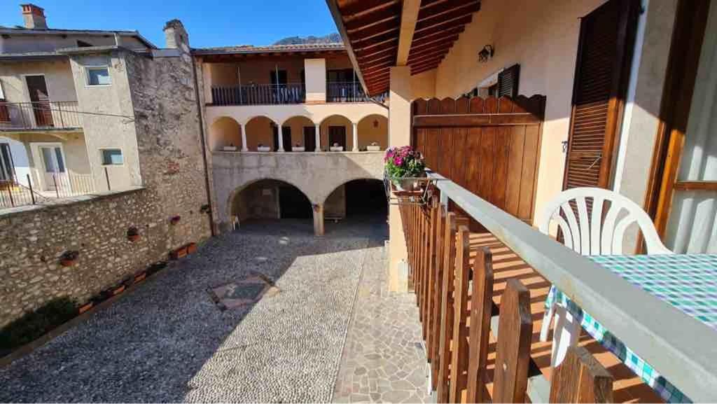 a balcony with a wooden fence and a building at Appartamenti Bonaventura in Tignale