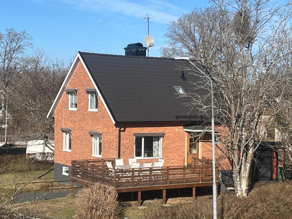 a red brick house with a black roof at Ferienhaus in Orrefors in Orrefors