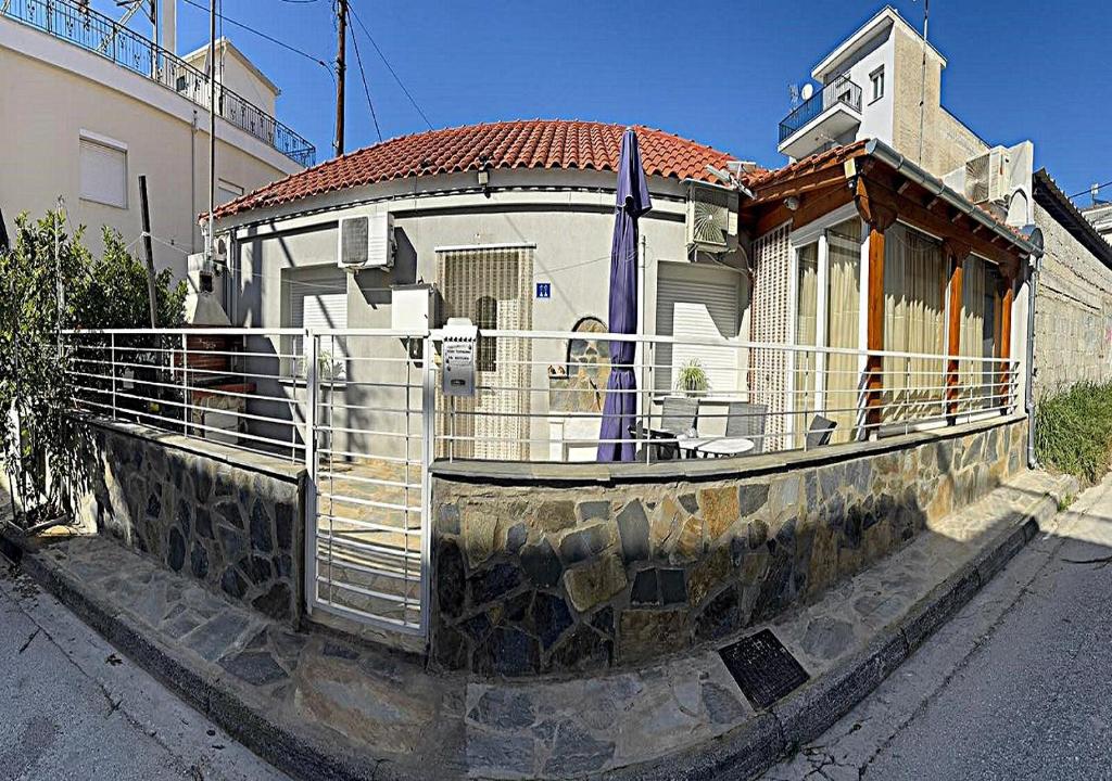 a building with a fence in front of it at Elias Home in Volos
