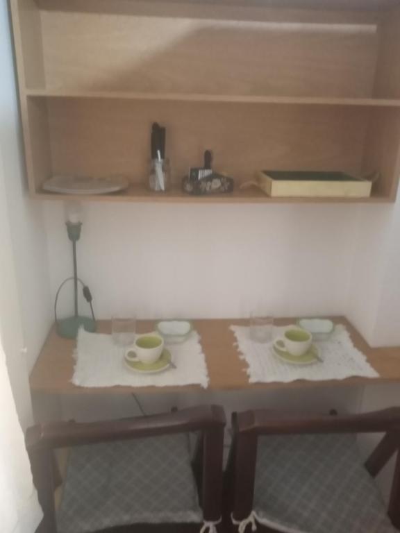 a miniature table with two cups and saucers on it at Pacor in Mar del Plata
