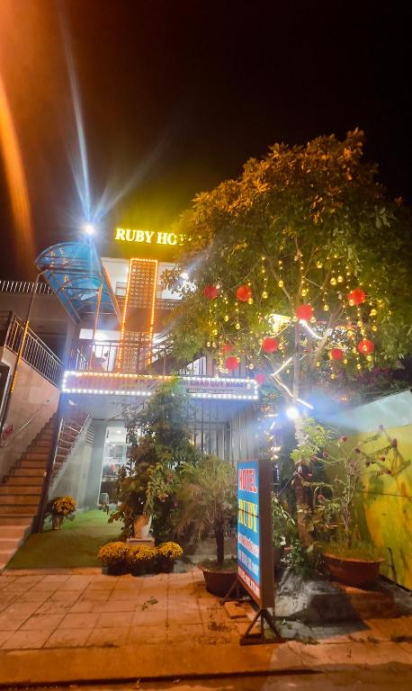 a building with a sign in front of it at night at Ruby Hotel in Nhơn Trạch