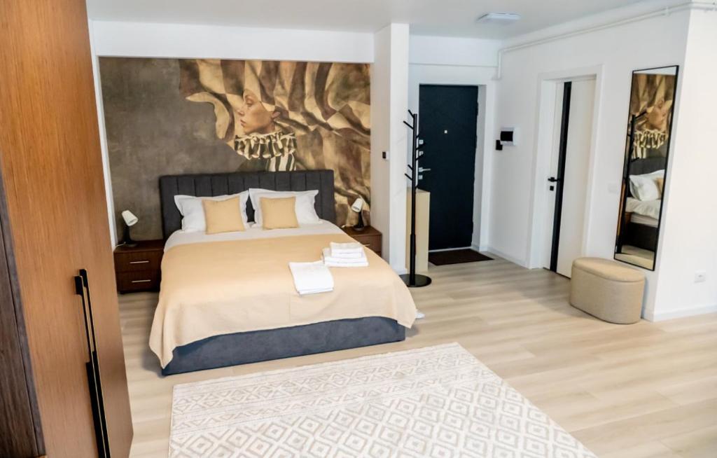 a bedroom with a bed with a painting on the wall at Piatra Studio in Piatra Neamţ