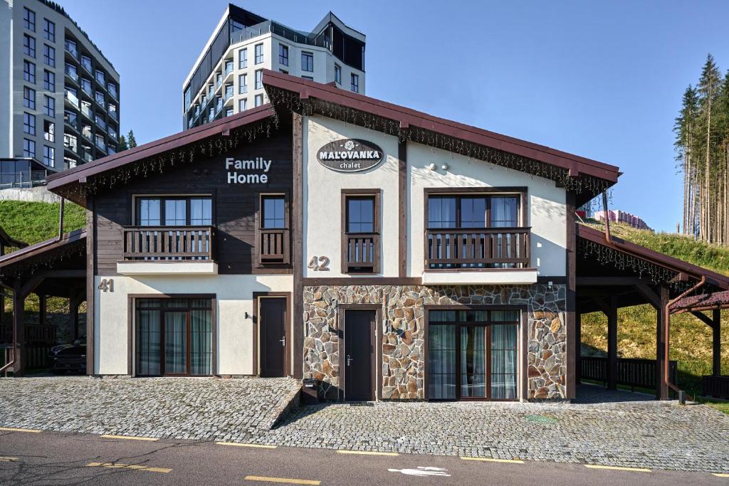 a building with a sign that reads family homes at Mal'ovanka in Bukovel
