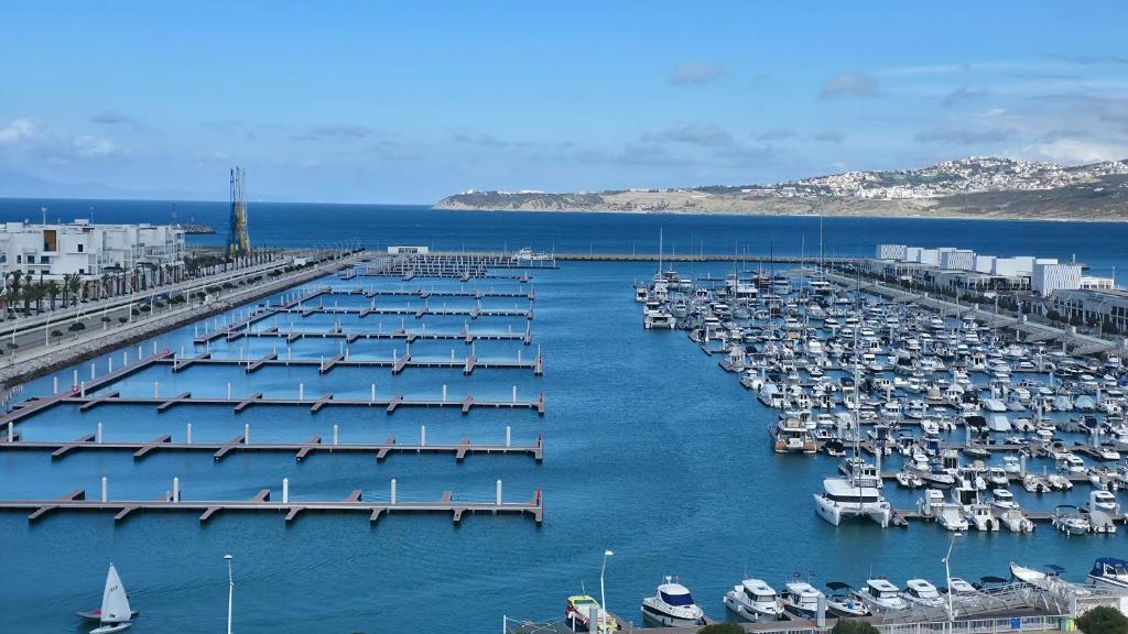 a group of boats docked in a harbor at Panoramic Sea View Apartment 1 Min Walk to Beach in Tangier