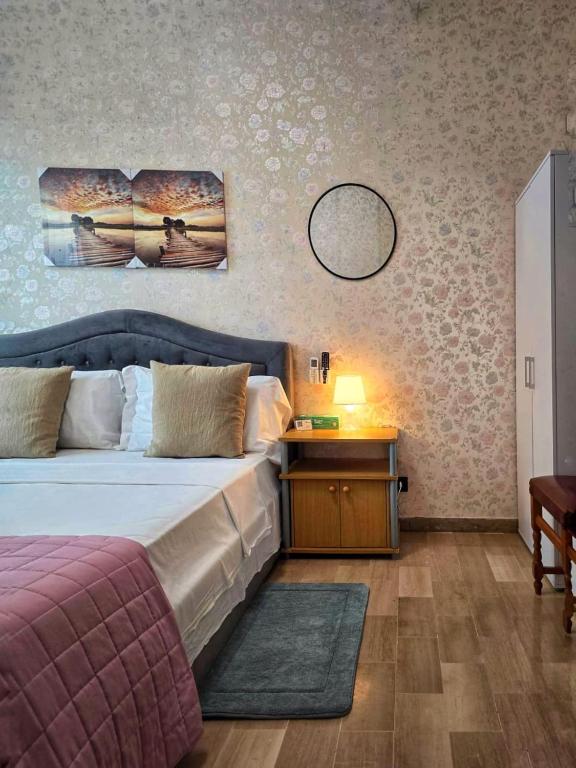 a bedroom with a bed and a table and a mirror at Altobello Venice Apartment in Mestre