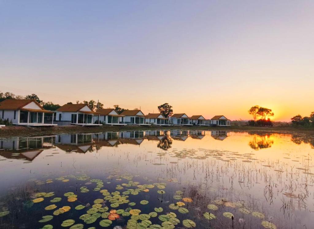 a view of a lake with houses and lily pads at Secret Terrace Pool Villa Rayong in Ban Bua Phut