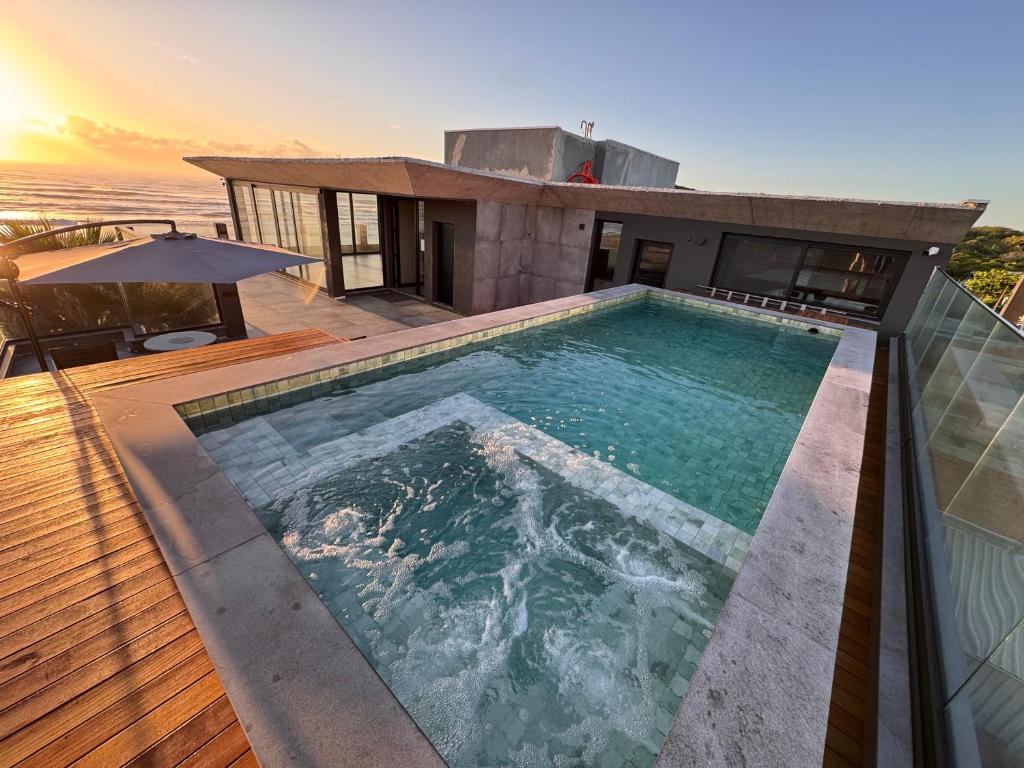 a swimming pool on top of a house at BALUARTE POUSADA in Torres