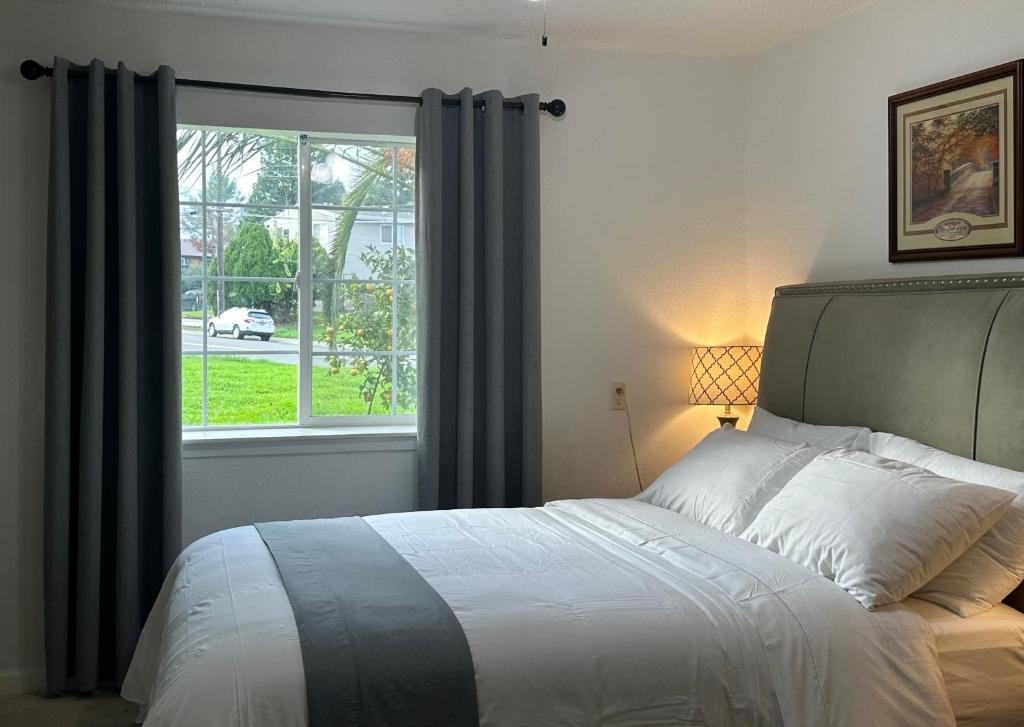 a bedroom with a large bed and a window at Suite A with a kitchen in Sacramento