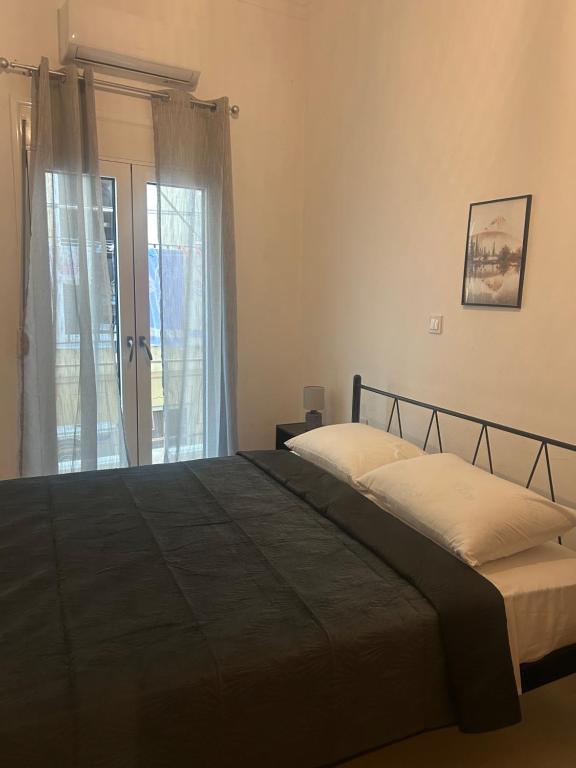 a bedroom with two beds and a window at MINAS CENTRAL apartments in Heraklio