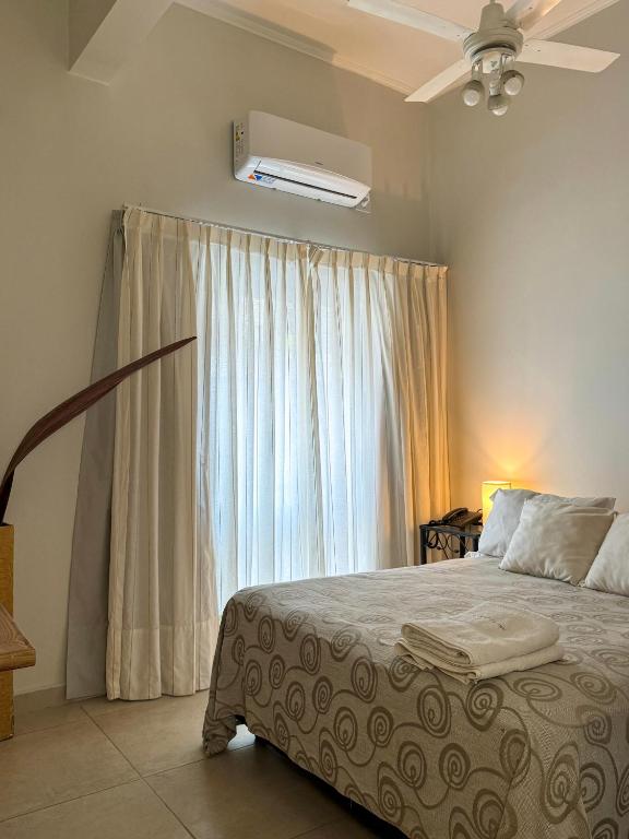 a bedroom with a bed and a window at Hotel Europa in Buenos Aires