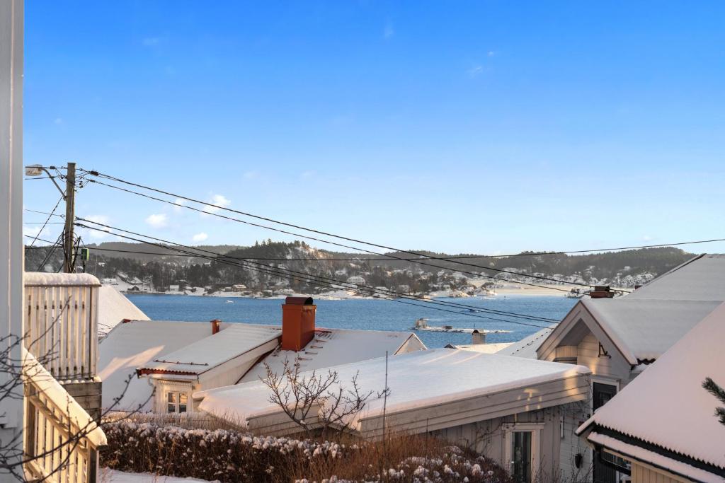 a group of houses with snow on the roofs at Hovedhuset in Kragerø