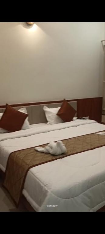 a pair of beds in a hotel room at The Nature Park Hotel in Mudhol
