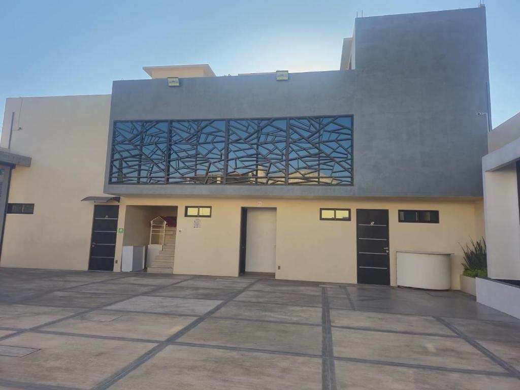 a building with a large window on the side of it at Hotel y Motel Elegantia in Tetelco