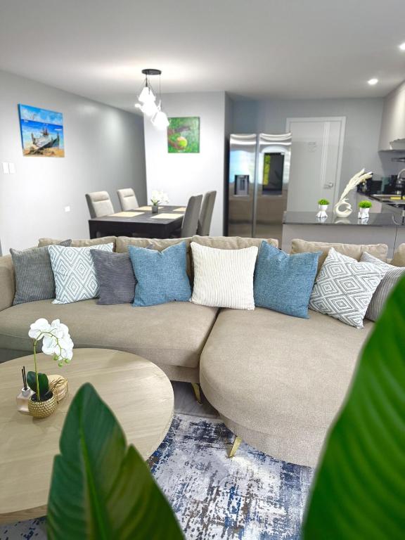 a living room with a couch and a table at The Gatehouse Tobago in Buccoo