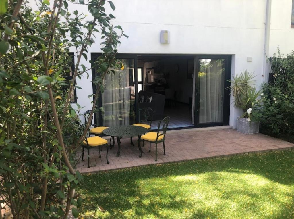 a patio with a table and chairs in a yard at The Karoo Condo in Montagu