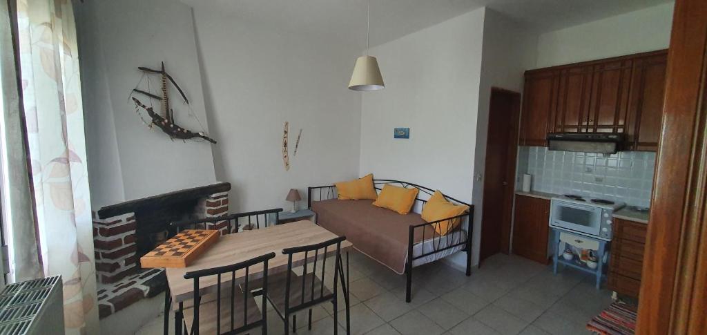 a living room with a couch and a table in a room at Karouti-Rooms for Rent in Pteleos