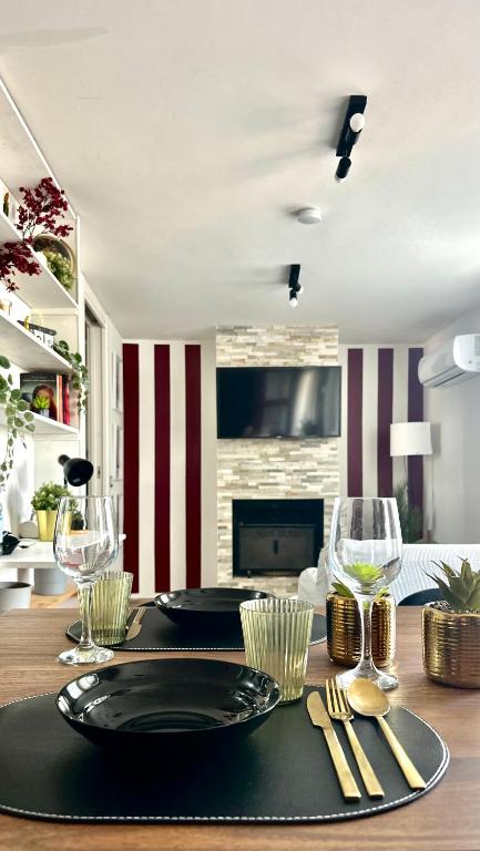 a dining room table with a plate and wine glasses at The Attic in Civitavecchia