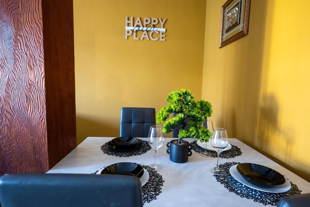 a dining room table with a happy marriage place sign on the wall at Casa Vacanze Aria 1 in Leggiuno