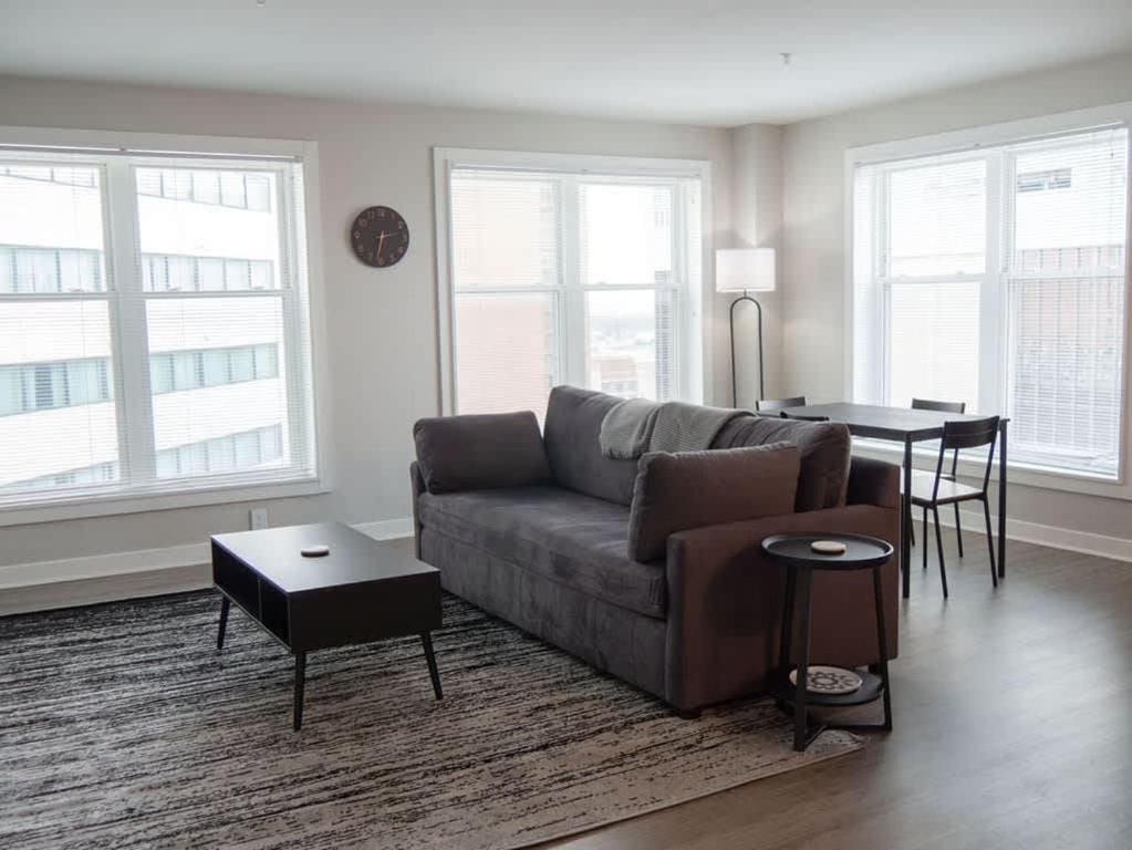 a living room with a couch and a table at Historic 2BR stay with patio & elevator in Indianapolis