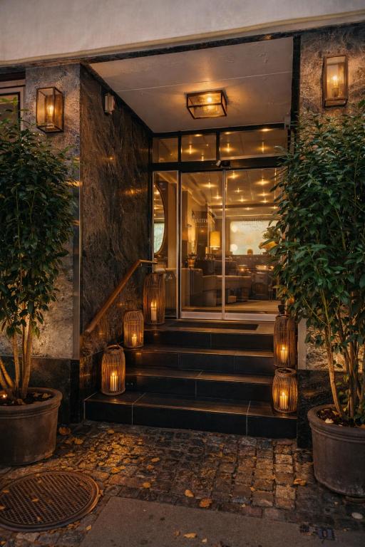 a lobby of a building with lights on the stairs at Hotel Maritime in Copenhagen