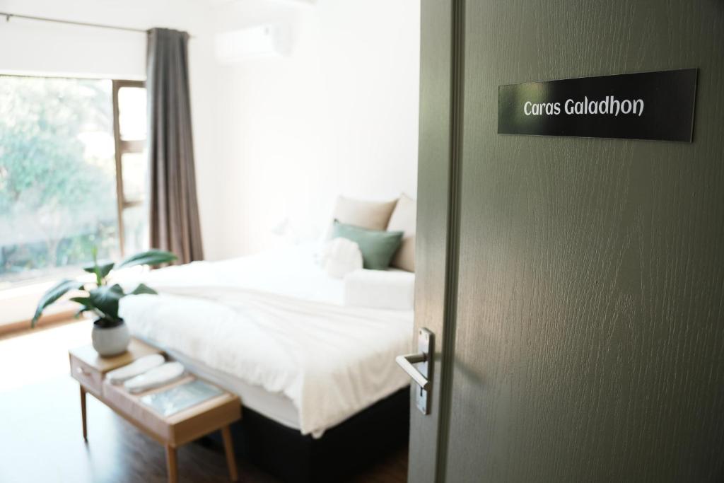 a bedroom with a bed and a door with a couch at Entire house perfect for group trips and families in Cape Town in Cape Town