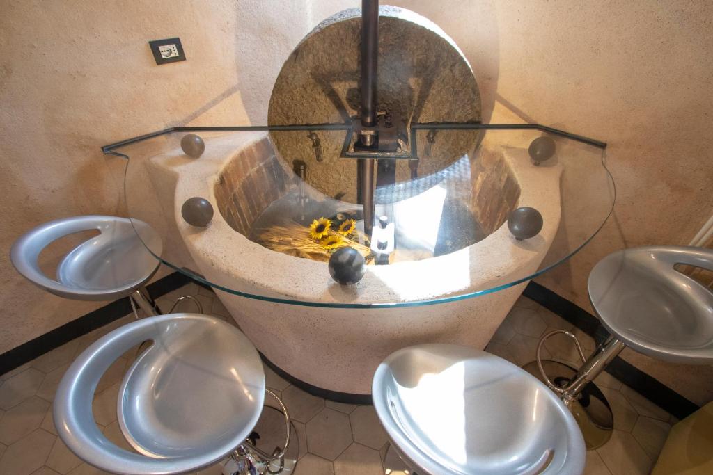 a bathroom with a sink with four urinals at Il Nuovo Vecchio Frantoio di Gardan Con Piscina in Vignana
