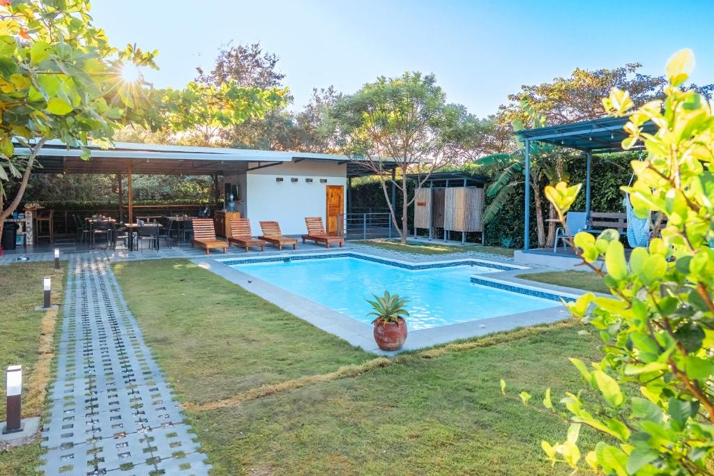 a swimming pool in the backyard of a house at Amazilia Guesthouse in Liberia