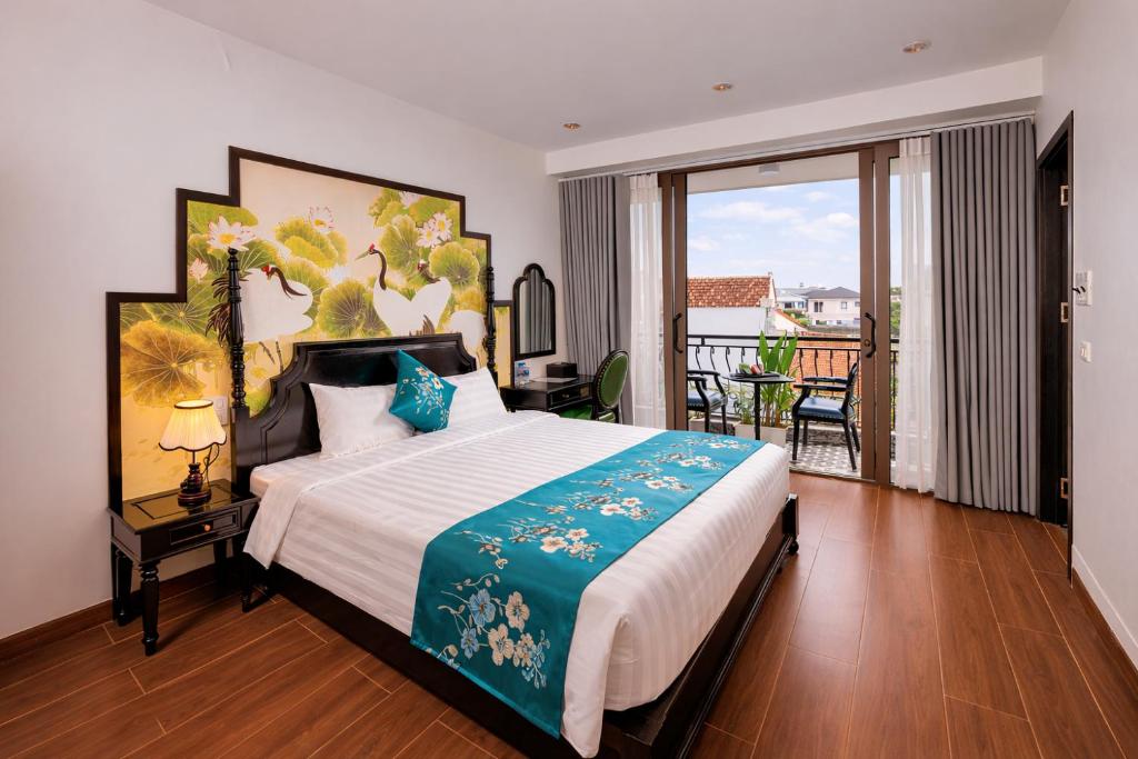 a bedroom with a large bed and a balcony at Tam Coc Center Friendly Hotel in Ninh Binh