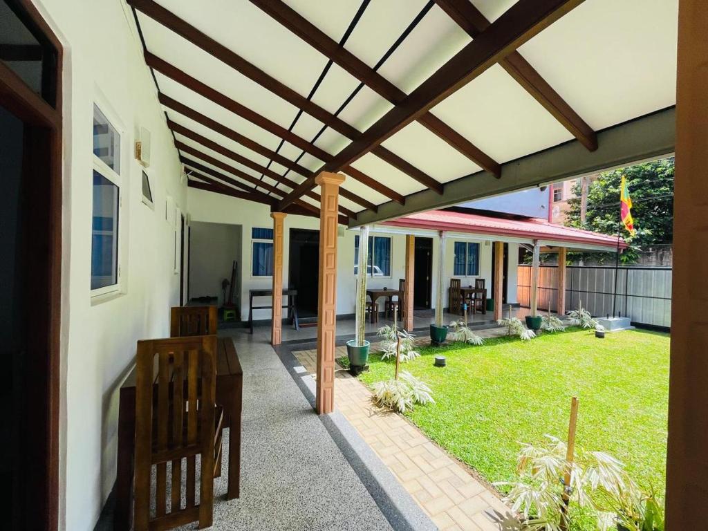 an outdoor patio with a wooden pergola at Emerald Coast Hotel Negombo in Negombo